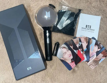 BTS Army Bomb Lightstick Special Edition with box, lightstick, user manual, strap, exclusive photocards, and dust bag on display